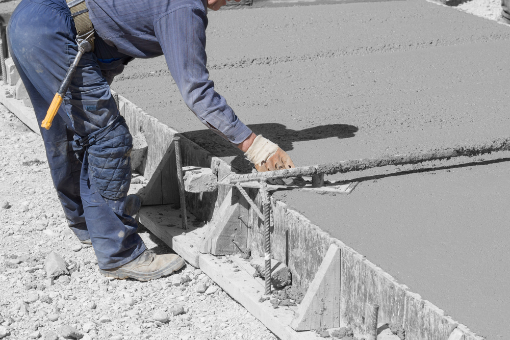 Construction,Worker,Leveling,Concrete,Pavement.